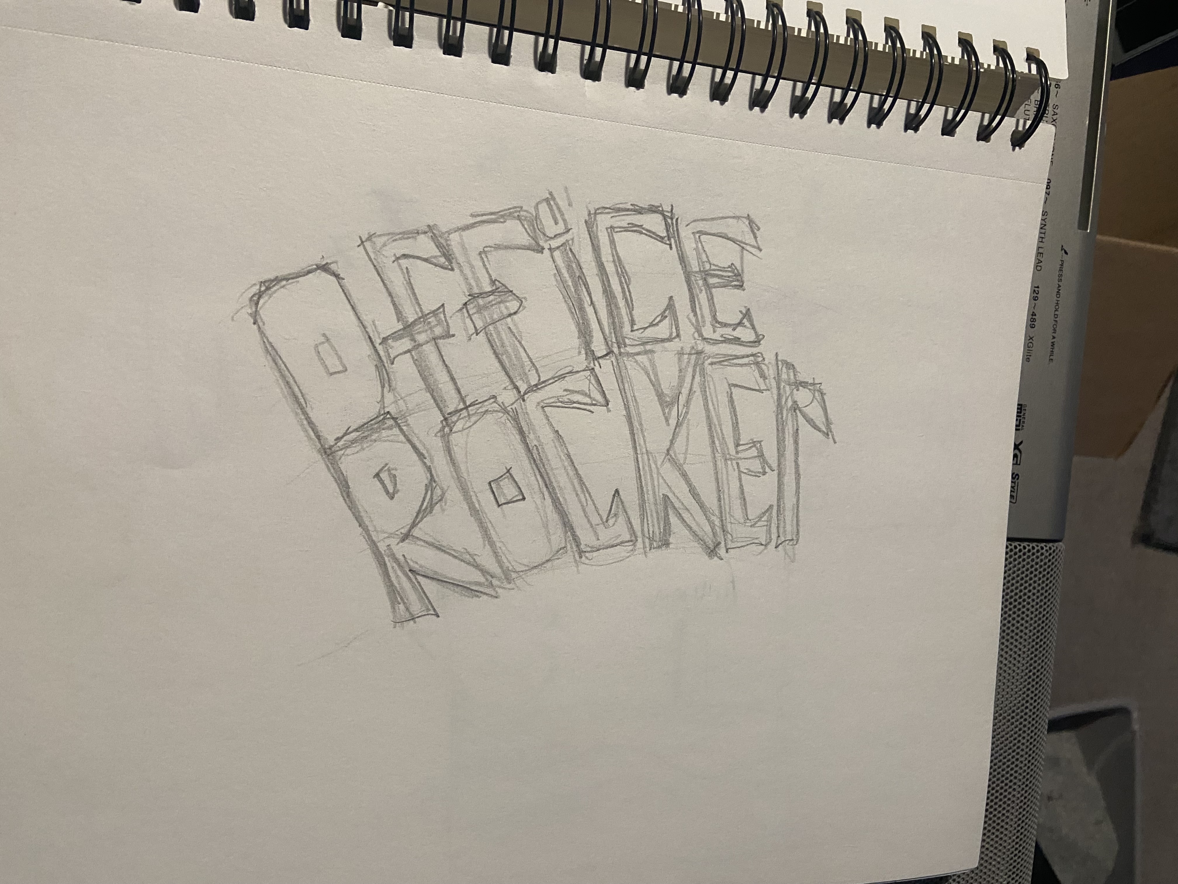 version 1 sketch for the office rocker drink logo drawn in a sketchbook.