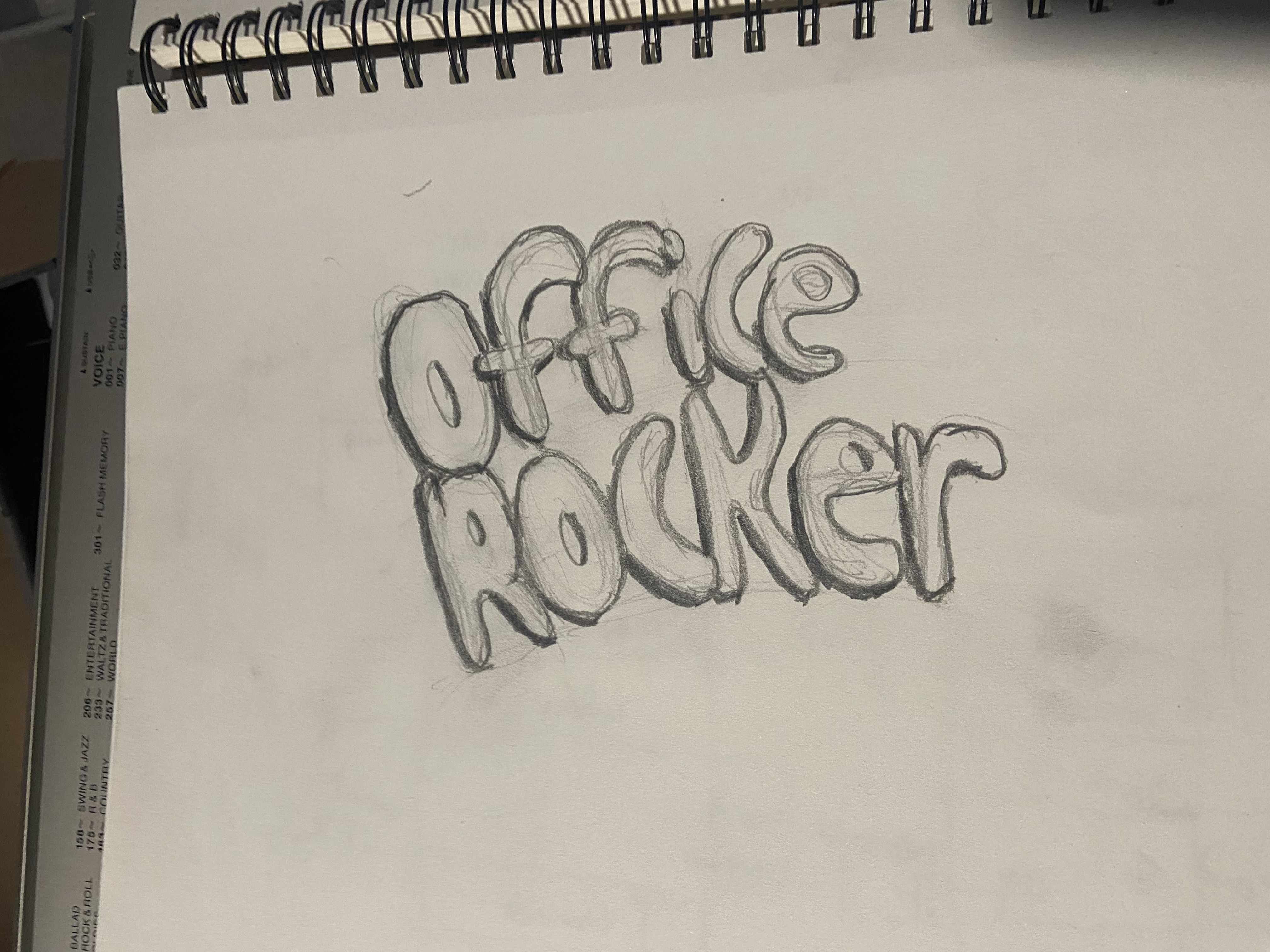 version 2 sketch for the office rocker drink logo drawn in a sketchbook.